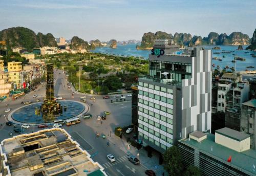a view of a city with a river and buildings at TiGon Hotel in Ha Long