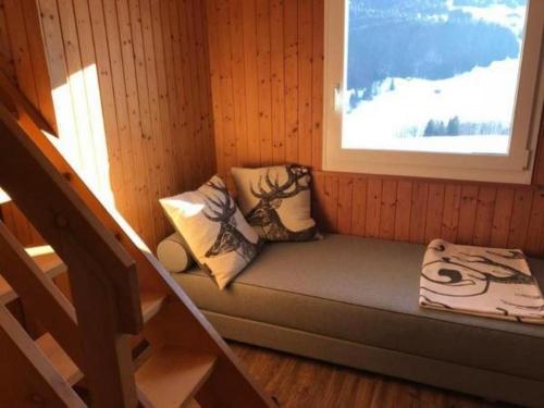 a small bench in a room with a window at Chalet Toggi in Wildhaus