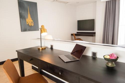 a room with a desk with a laptop on it at GLOW PARK HOTEL Grand Royal Palace in Phnom Penh