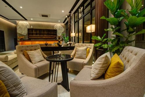a living room with two couches and a table at GLOW PARK HOTEL Grand Royal Palace in Phnom Penh