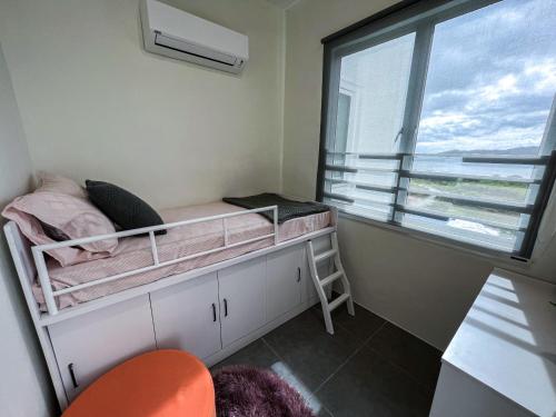 a small bedroom with a bunk bed and a window at Ins2 Langkawi Apartment Kuah in Kuah