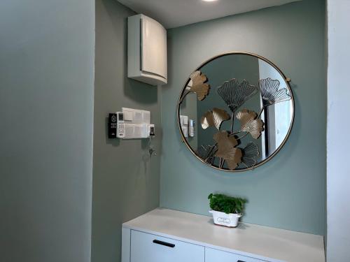 a bathroom with a mirror and a white cabinet at Ins2 Langkawi Apartment Kuah in Kuah