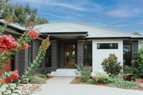 a house with a black and white at The Top Spot - A Modern All-Season Retreat in Mudgee