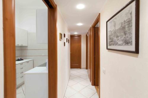 a kitchen with a hallway with a sink and a picture at New Apartment Sistina Trevi-Spagna in Rome