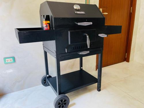 a bbq cart with a grill on wheels at Hanamitsu Hotel & Spa in Garapan
