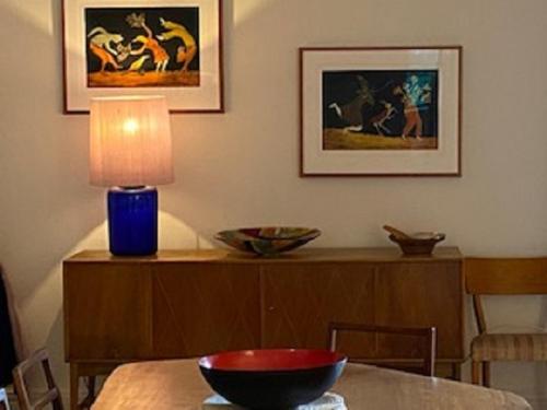 a dining room table with a bowl on top of it at West End Apartments in Fremantle