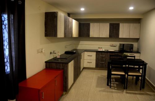 a small kitchen with a table and chairs in it at The Butterfly Luxury Serviced Apartments in Visakhapatnam