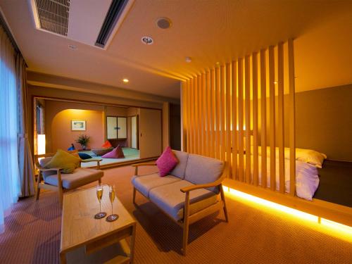 a living room with a couch and a table at Iki Stellacote Taiankaku in Iki