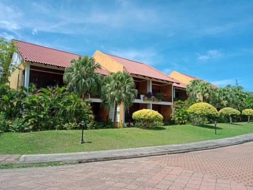 a house with a red roof on a street at Tiara Labuan Hotel in Labuan