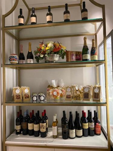 a shelf filled with lots of bottles of wine at Taj Hotel Cape Town - Taj Residence suites in Cape Town