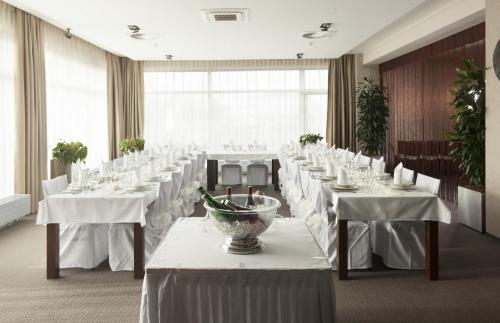 a large banquet room with white tables and chairs at Wellness Hotel ABÁCIE in Nový Jičín