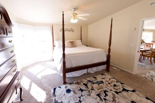 a bedroom with a bed and a ceiling fan at Spacious Peaceful Country Home 1 Mile from Town 