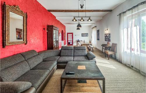 a living room with a couch and a red wall at Lovely Home In Laurens in Laurens