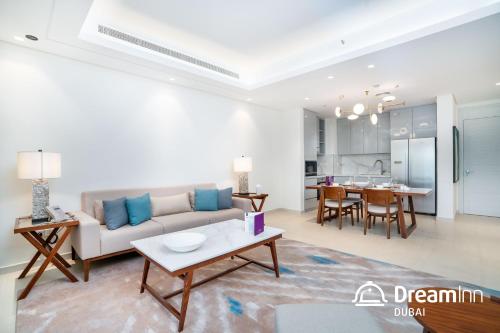 a living room with a couch and a table at Dream Inn Apartments - Address Beach Residence Fujairah in Fujairah