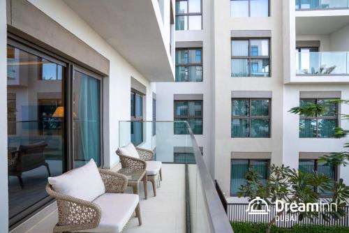 a balcony in a building with chairs and tables at Dream Inn Apartments - Address Beach Residence Fujairah in Fujairah