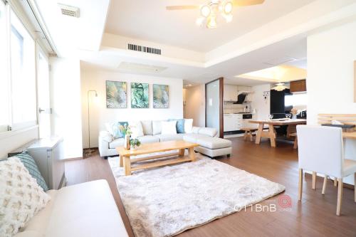 a living room with a couch and a table at NK BLD6F Sapporo 3LDK 3BR 1 floor 1 room in Sapporo