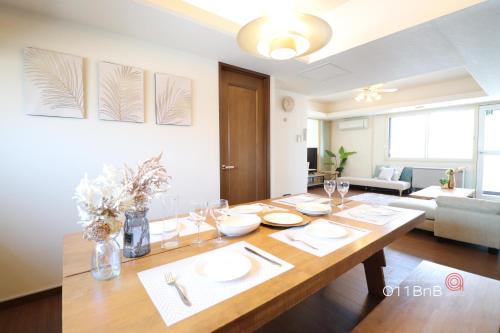 a dining room with a table and a living room at NK BLD6F Sapporo 3LDK 3BR 1 floor 1 room in Sapporo