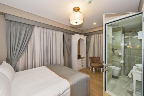 a bedroom with a bed and a shower and a bathroom at Hanna Hotel in Istanbul
