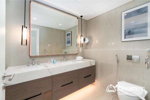 a bathroom with a sink and a mirror at Dream Inn Apartments - Address Beach Residence Fujairah in Fujairah