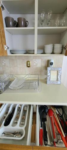 a kitchen cabinet filled with lots of utensils at Right Next To WEST EDMONTON MALL with Free Parking in Edmonton