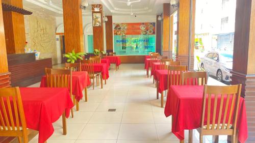 a dining room with red tables and chairs in a restaurant at SM Patong Resort in Patong Beach