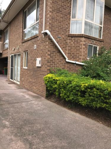 a brick building with a pipe on the side of it at Bethel Homestay in Watsonia North