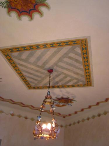 a chandelier hanging from a ceiling with a mirror at Bed & Breakfast Villa Palma in Lovere
