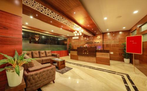a lobby with two couches and a table at MARZA INN in Kalpetta
