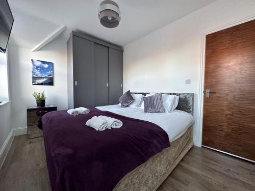 a bedroom with a large bed with towels on it at Brooklands Filey Seaside Retreat Flat 6 in Filey
