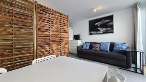 a living room with a couch and a bed in it at Beautiful Studio With Patio Carrapateira in Carrapateira