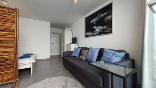a living room with a couch and a table at Beautiful Studio With Patio Carrapateira in Carrapateira