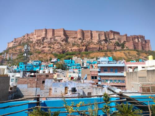 a view of a city with a mountain in the background at Namaste Caffe-for heritage stay in Jodhpur