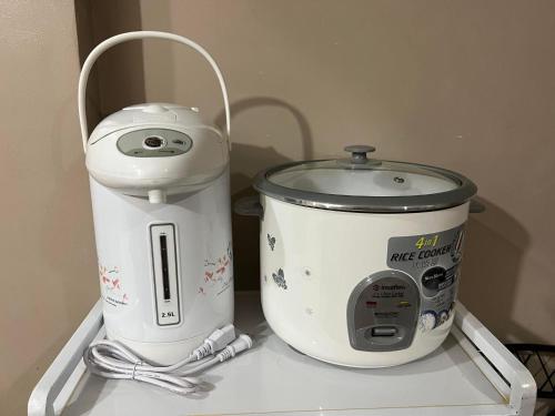 a slow cooker and a food processor on a shelf at Townes Huge Home Big Grps Big Fam Near SM Ecoland DGT Coastal road ADDU UM in Davao City