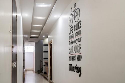 a hallway with a wall with bikes on it at Nova Inn in Gorakhpur
