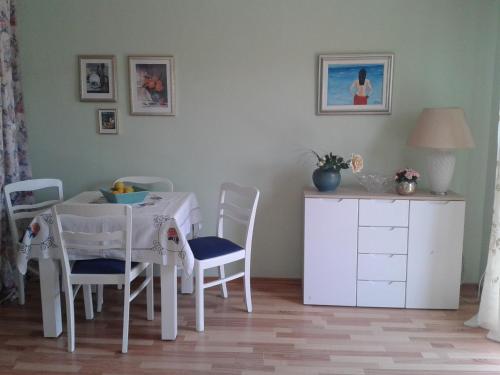 una sala da pranzo con tavolo e sedie bianchi di Apartment Splitska a Splitska