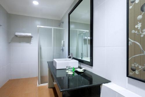 a bathroom with a sink and a mirror at Palace Hotel in Puncak