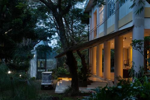 a house with a golf cart parked in front of it at Palace Hotel in Puncak
