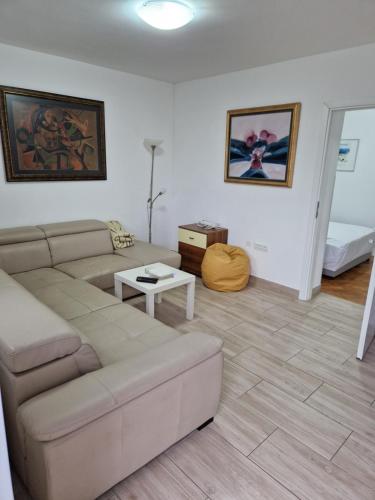 a living room with a couch and a table at Grbaste51-Svilno,Rijeka in Rijeka