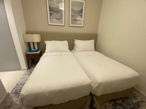 two beds in a small room with at Address Beach Resort Fujairah Apartment 2 Bed Rooms and Small Bed Room - Ground Floor 3011 in Al Aqah