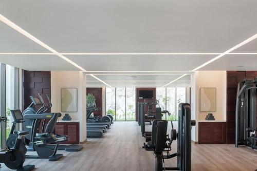 a gym with rows of treadmills and machines at Address Beach Resort Fujairah Apartment 2 Bed Rooms and Small Bed Room - Ground Floor 3011 in Al Aqah
