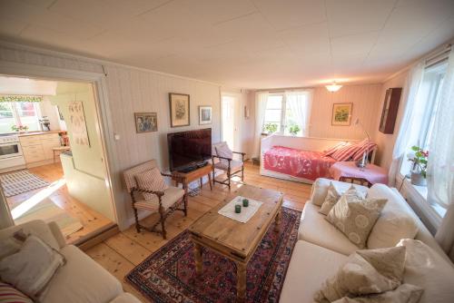 a living room with a couch and a table at Huset Lövhyddan - SWEEDS Loftahammar in Loftahammar