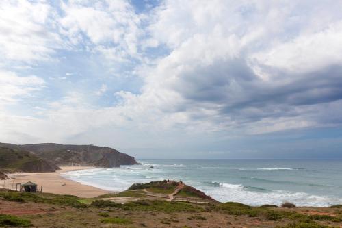 a view of a beach and the ocean on a cloudy day at Sea View Apartment Carrapateira in Carrapateira