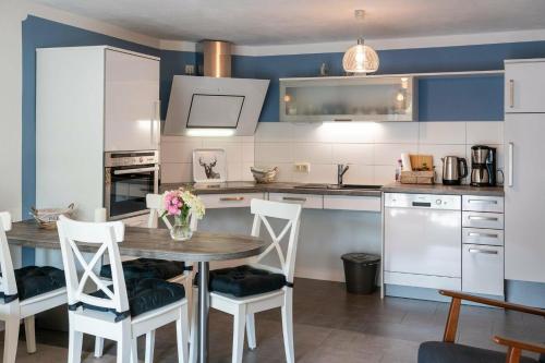 a kitchen with a wooden table with chairs and a table at NEU! Ferienwohnung Andreas Radebeul in Radebeul