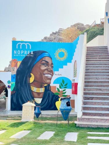 a mural of a woman on the side of a building at Noprea Boutique Hotel in Aswan