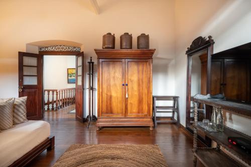 a living room with a wooden door and a couch at 42 Lighthouse Street in Galle