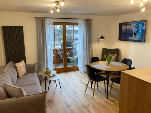 a living room with a couch and a table at Ferienwohnung Einklang in Krün