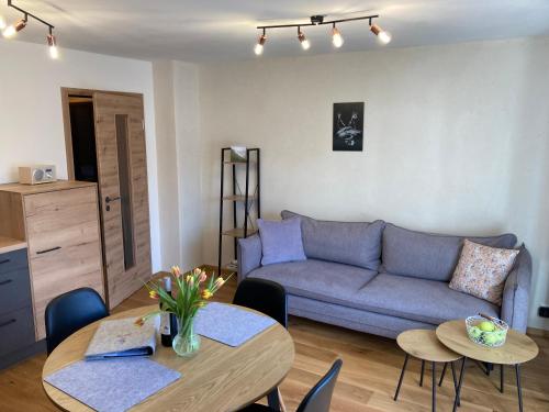a living room with a couch and a table at Ferienwohnung Einklang in Krün
