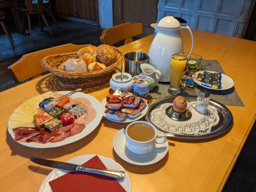 a table topped with plates of food and cups of coffee at Gasthof Adler in Zusmarshausen