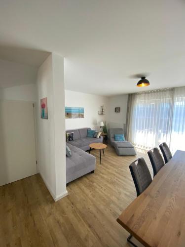 a living room with a couch and a table at Ferienhaus 14 "Gut Tossens" in Tossens
