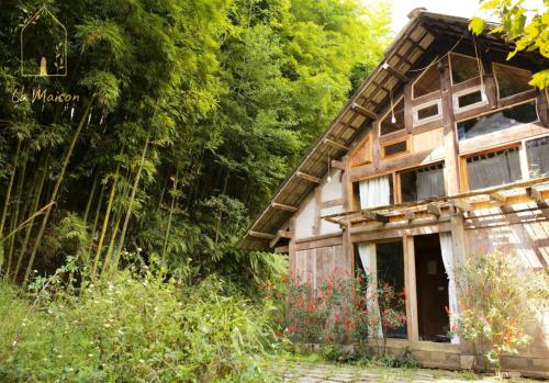 an old wooden house in the woods with trees at Sa Moc - La Maison House & Bungalow in Sa Pa